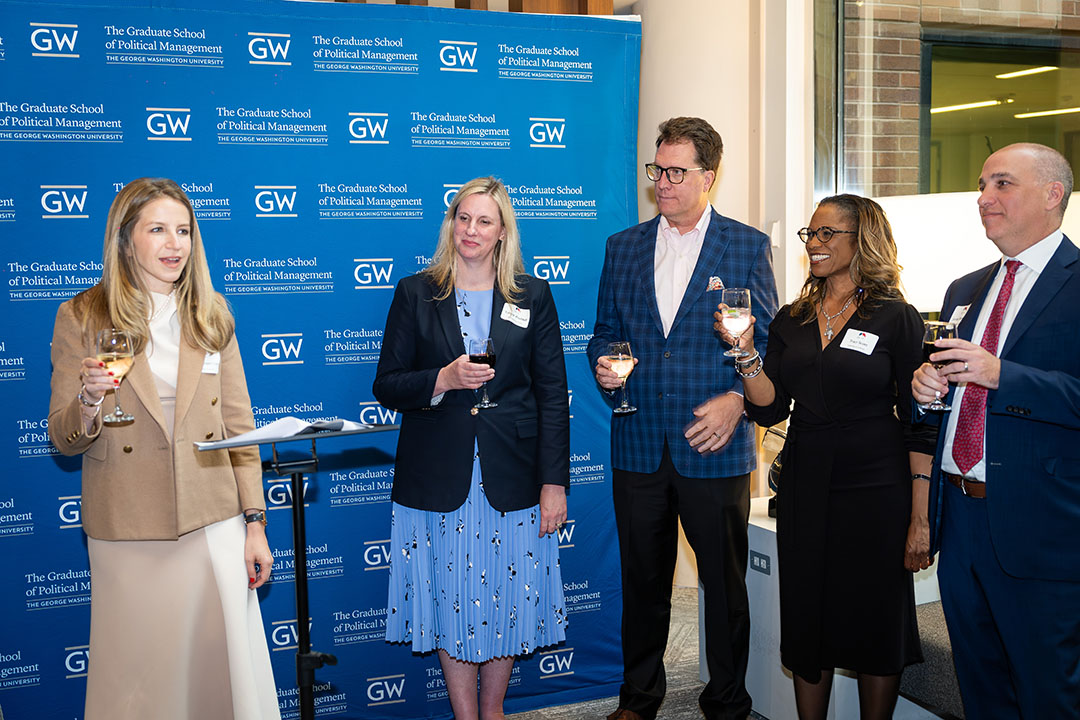 Carly Cooperman, Tiffany Waddell, Robert Hoopes, Traci Scott, and Jordan Bernstein standing and toasting with raised glasses