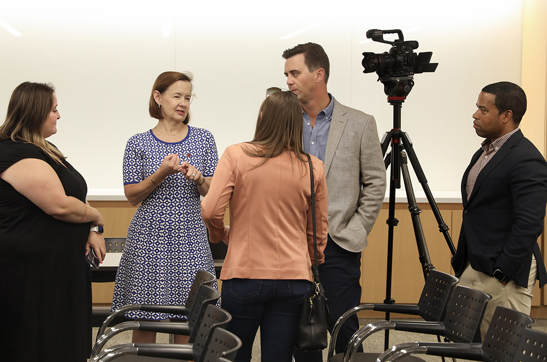 group of 3 women and 2 men talking with camera on tripod