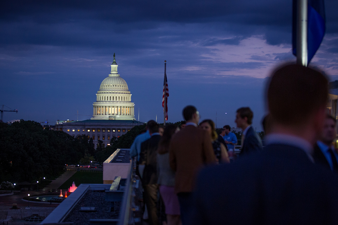 networking reception at night with US Capitol in the background