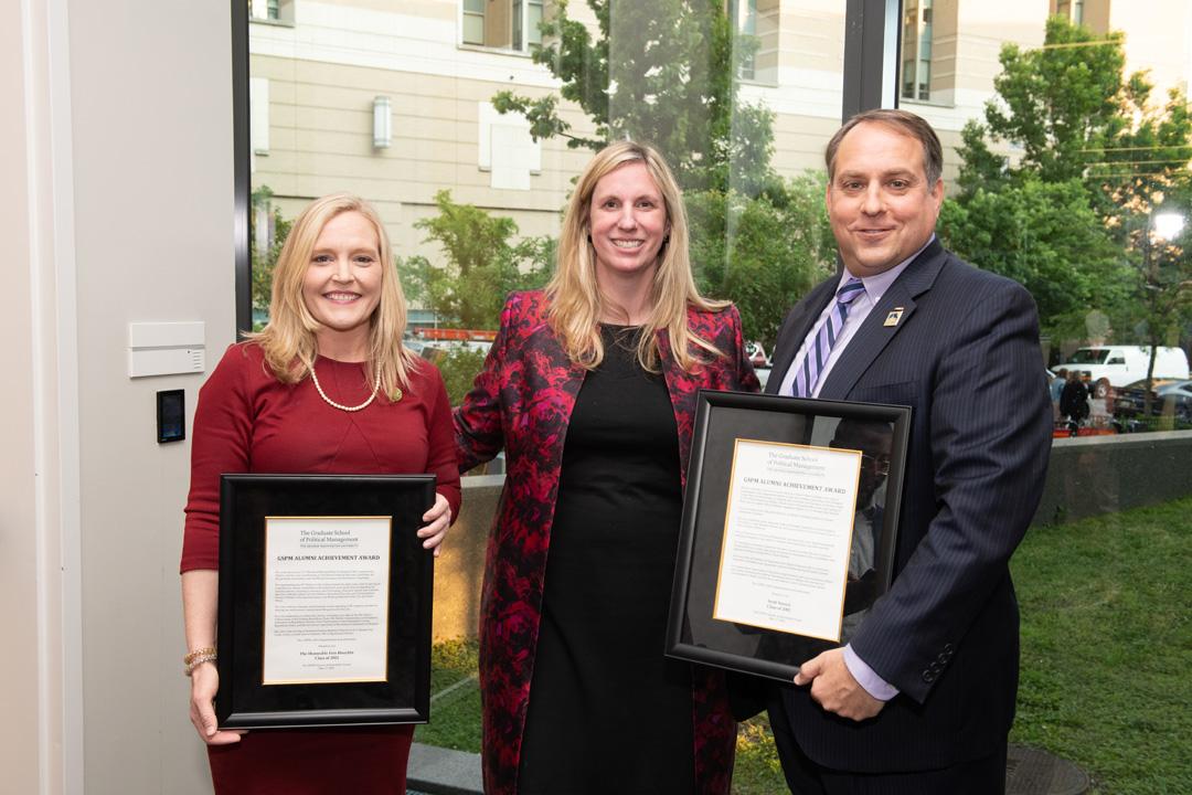 Erin Houchin and Scott Suozzi holding their alumni achievement awards with Tiffany Waddell smiling between them